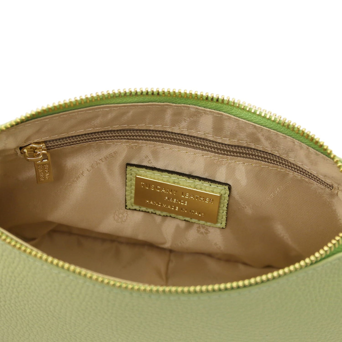 Bottom edge of lime green pebbled leather clutch with a centered seam and rounded base.
