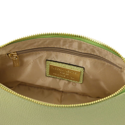 Bottom edge of lime green pebbled leather clutch with a centered seam and rounded base.