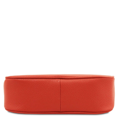 Parfait leather clutch in red with pebbled texture shown from a side view.