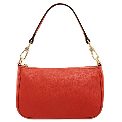 Red leather clutch with gold zipper and gold circular logo on the front against a white background
