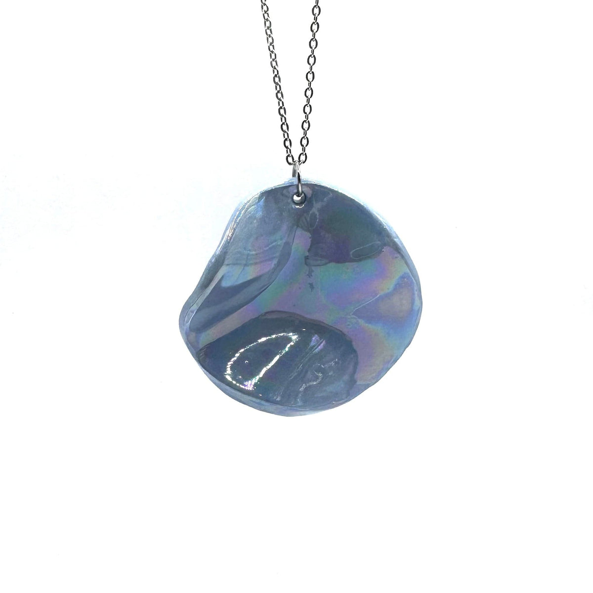Iridescent blue ceramic pendant necklace on a silver chain against a white background