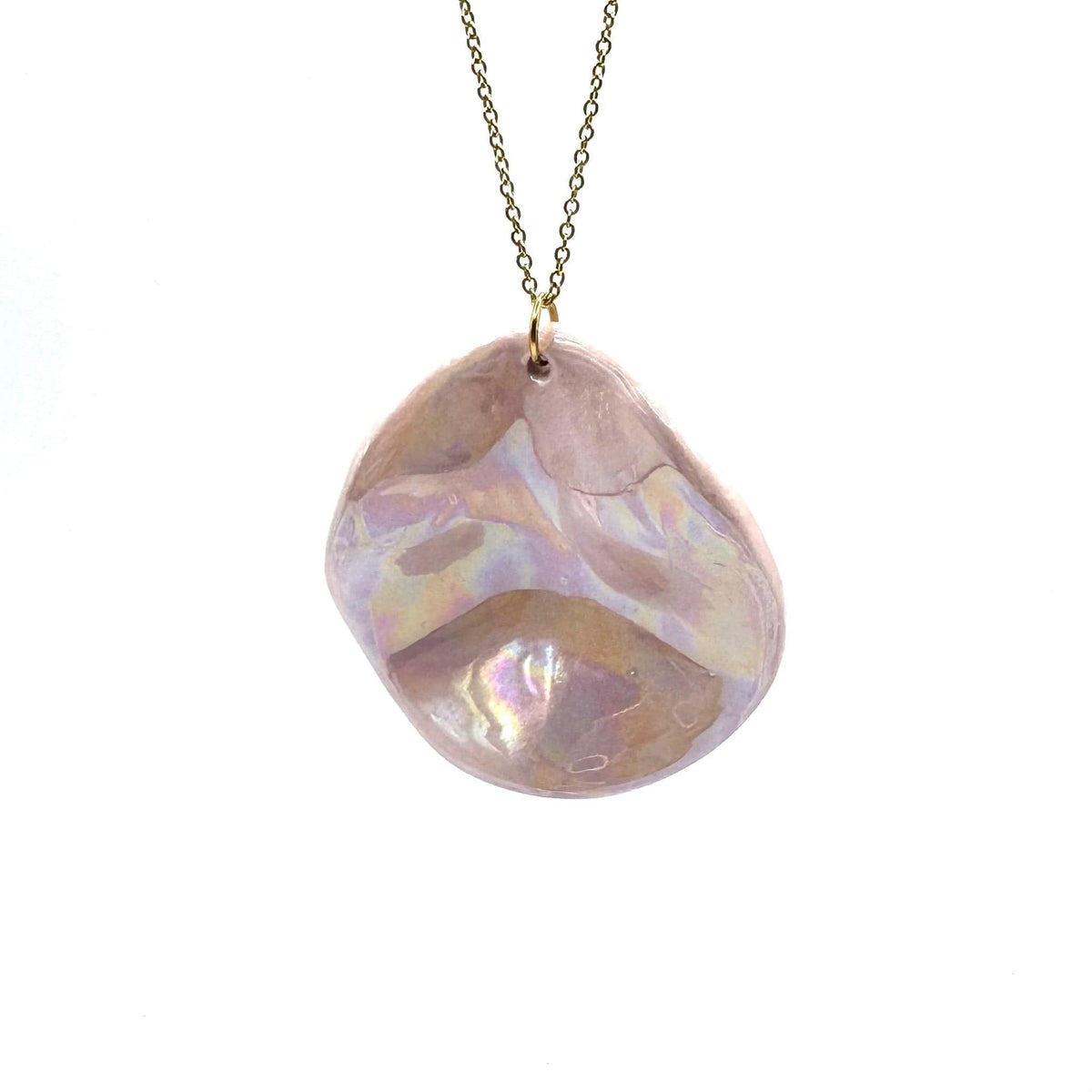 Pearl-pink ceramic pendant necklace on a gold chain against a white background