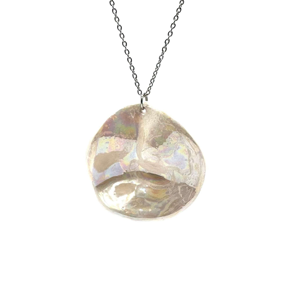 Large irregular pearl-white ceramic pendant on a silver chain.