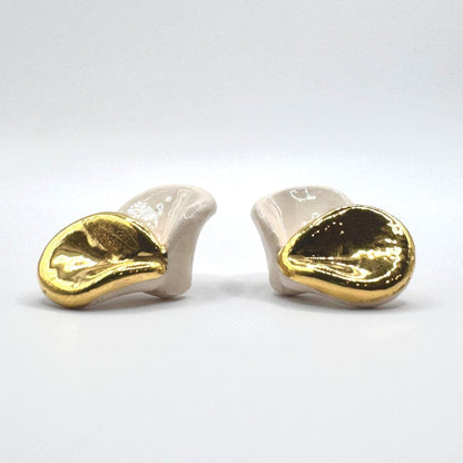 Petali white ceramic stud earrings with gold luster on a white background