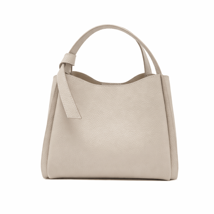 Beige handbag with a strap on a white background