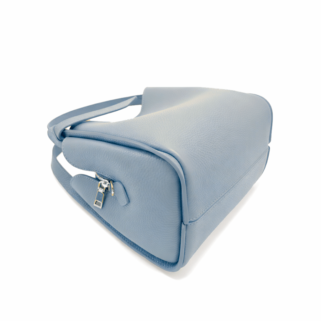 Side view of Pienza light blue leather tote showing a zipper top and pale interior lining