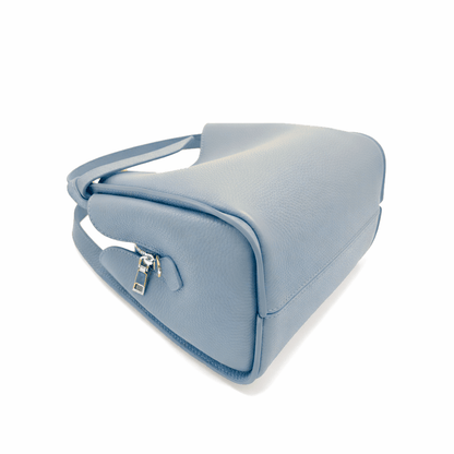 Side view of Pienza light blue leather tote showing a zipper top and pale interior lining