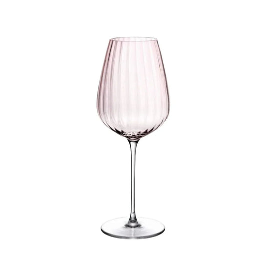 Dusty rose ribbed white wine glass with a long slender stem against white background