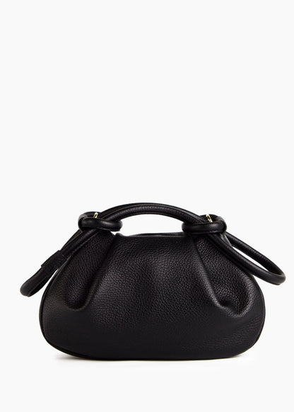 A black pebbled leather handbag with a top handle and a knotted leather detail on the handle, photographed against a plain white background.