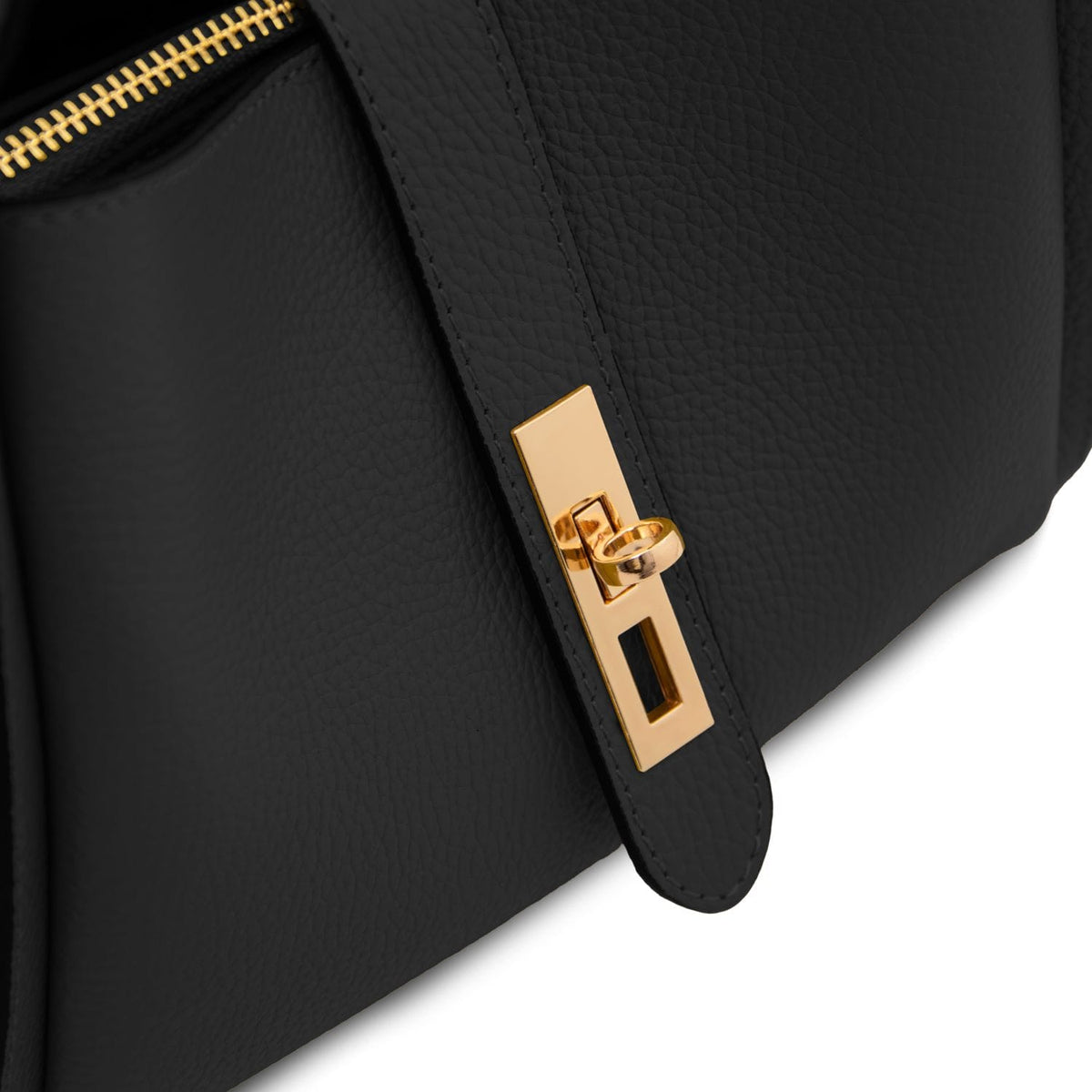 Close-up of black pebbled leather handbag with a gold rectangular clasp on the strap