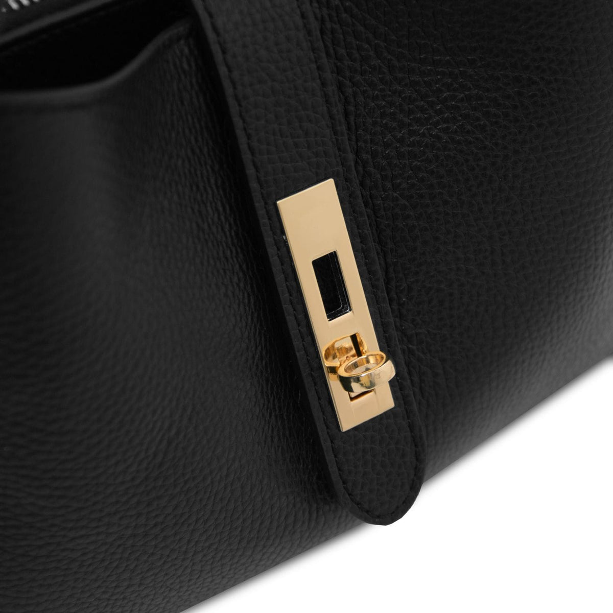 Gold latch detail on the side of the black leather handbag with pebbled texture