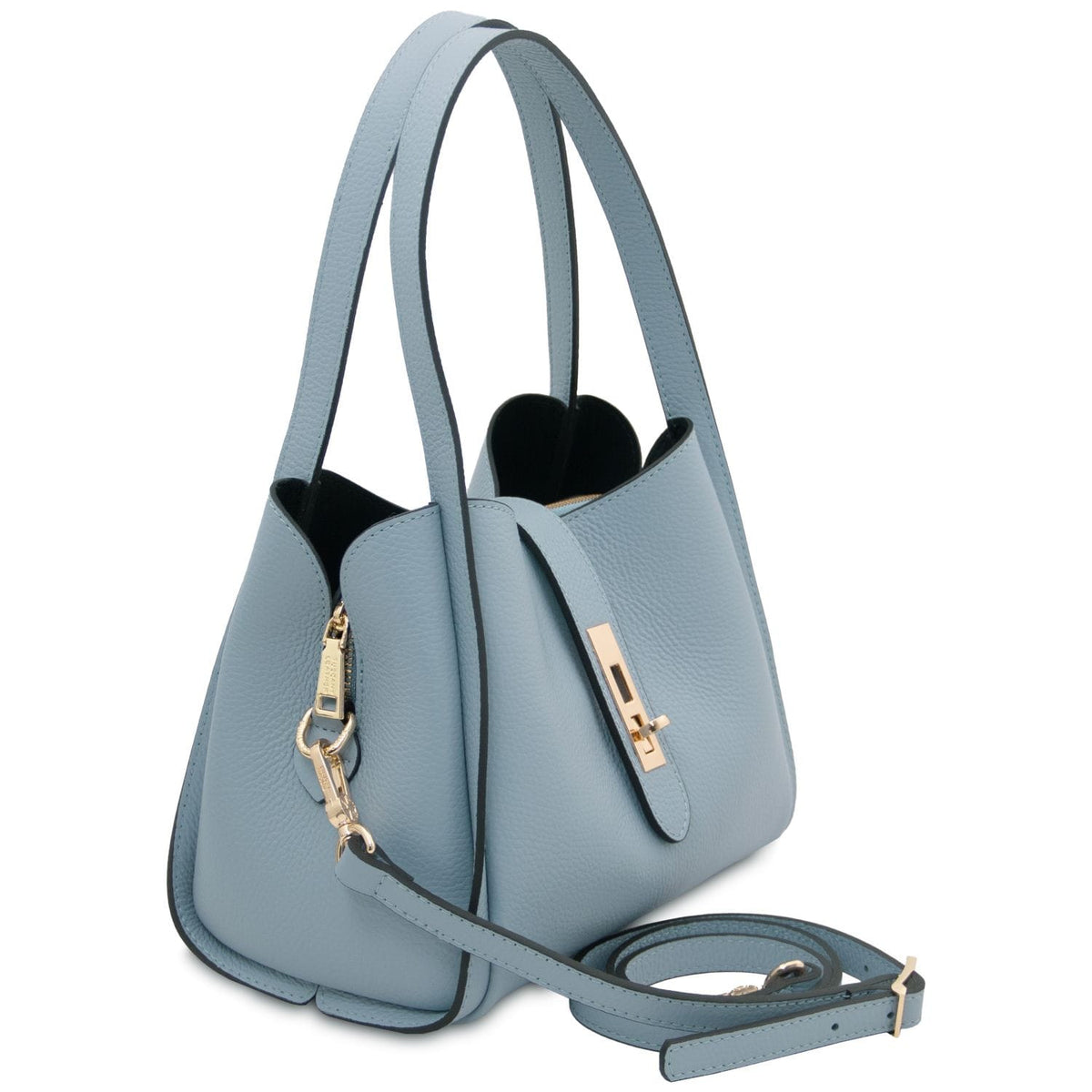 Three quarter view of light blue pebble leather handbag with detachable strap and gold hardware