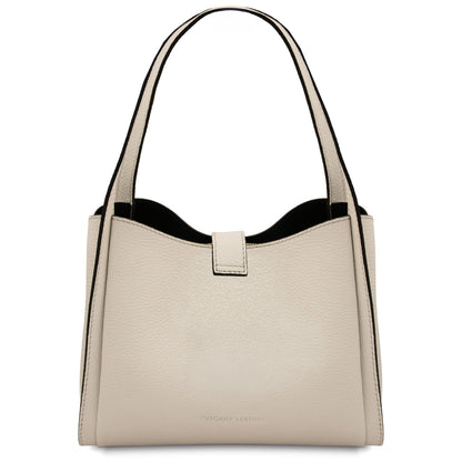 Cream beige soft leather handbag with two top handles and gold hardware on a white background