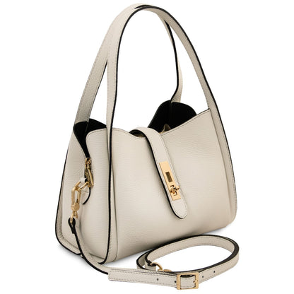 Beige pebbled leather handbag with dual top handles and a detachable strap finished with gold hardware