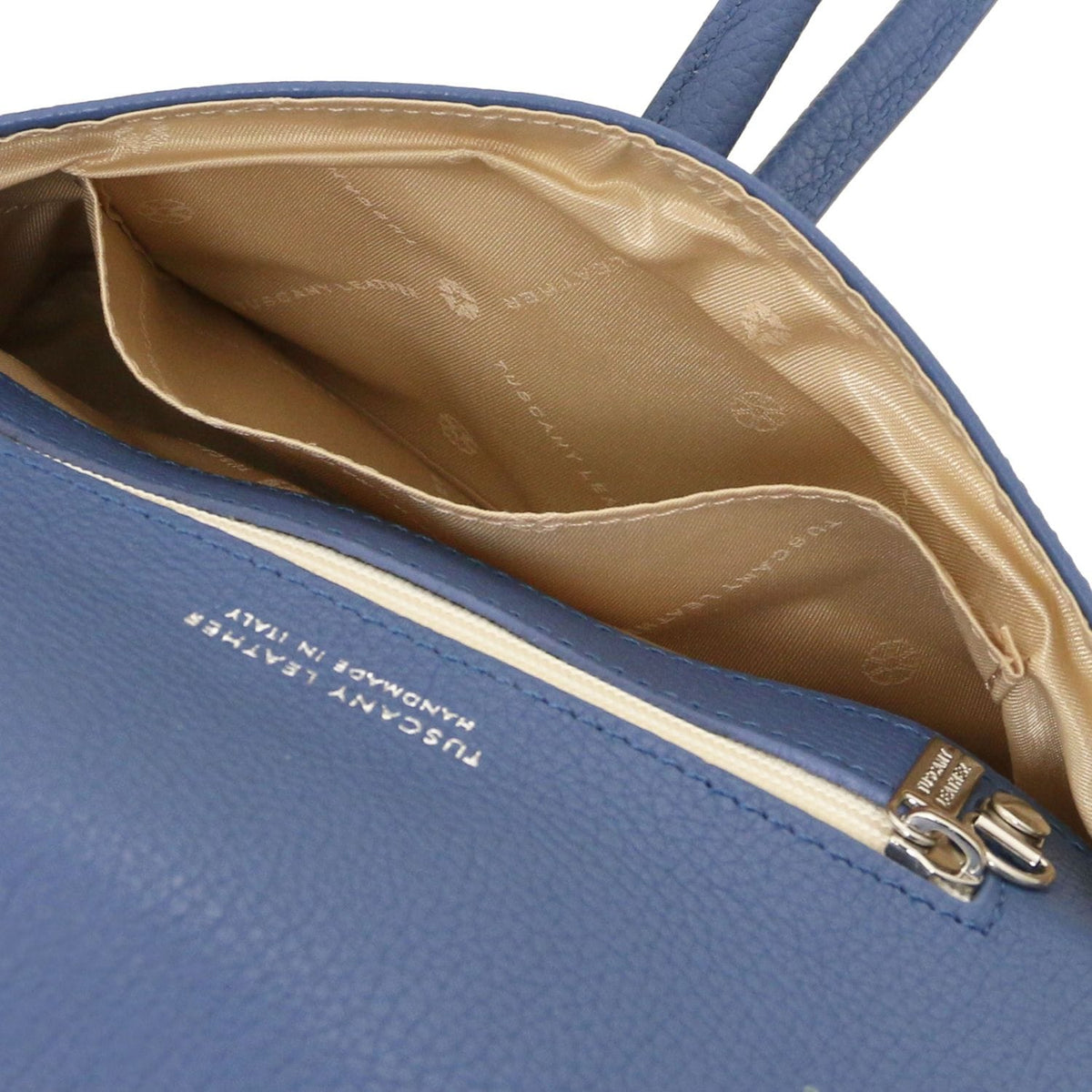 Ouvert blue leather clutch with beige patterned lining and internal pocket.