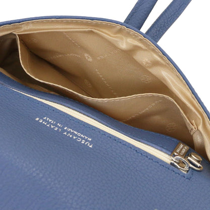 Ouvert blue leather clutch with beige patterned lining and internal pocket.