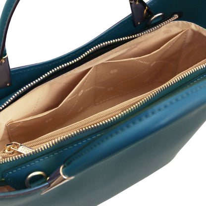 Interior view of teal TL Bag with beige lining and a zippered pocket