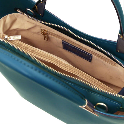 Teal TL Bag interior opened to reveal beige lining with a zip pocket and slip compartments