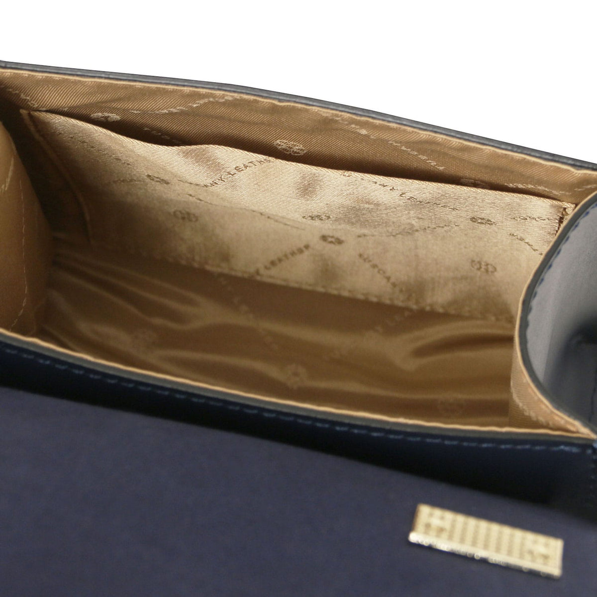 TL Bag - Leather mini bag | TL142203 in navy leather with gold-tone logo plaque and beige fabric interior lining on white background.