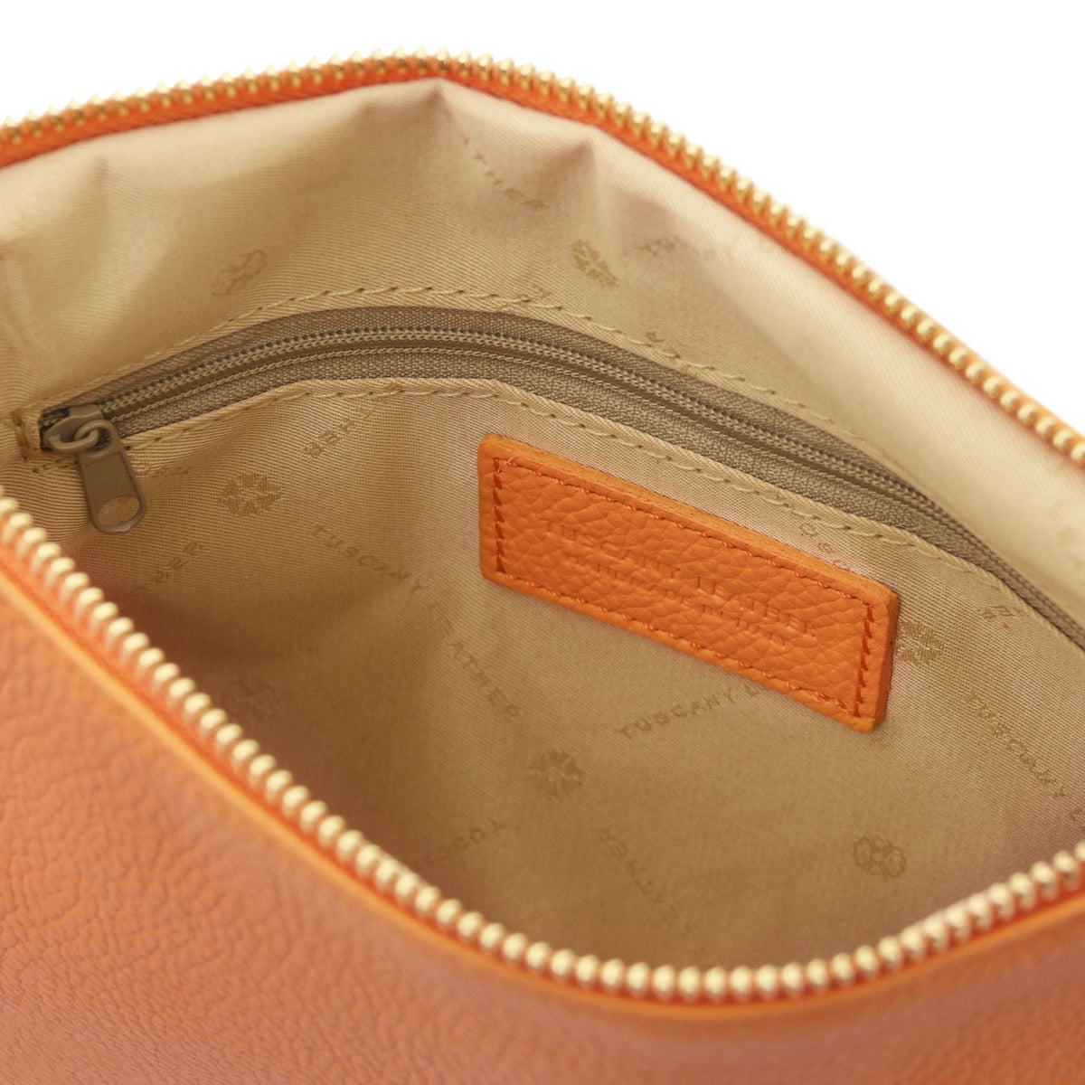 Interior view of soft orange Italian leather pouch clutch showing fabric lining with branded print and zippered pocket detail