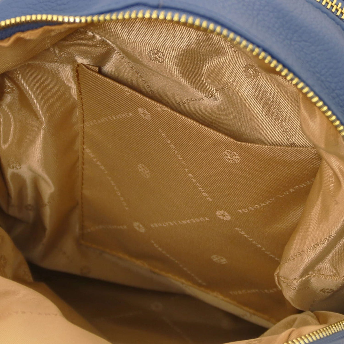 Interior of TL Bag blue leather backpack with cognac satin lining and a poche ouverte.