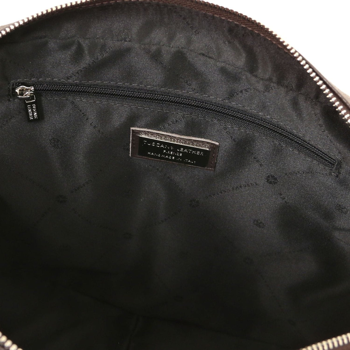 Interior of Treviso leather laptop briefcase with a zip pocket and a brand label on the lining