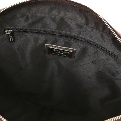 Interior of Treviso leather laptop briefcase with a zip pocket and a brand label on the lining