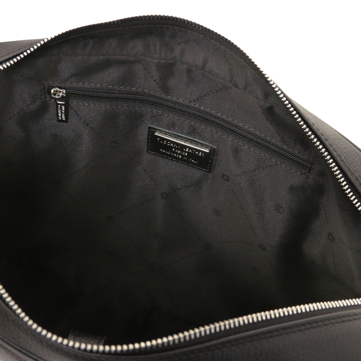 Inside view of Treviso leather laptop briefcase with zip pocket and brand plaque on black lining.