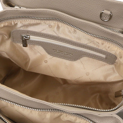 Open view of Tulipan Italian leather handbag showing beige satin interior lining and zippered pocket with leather trim detail.
