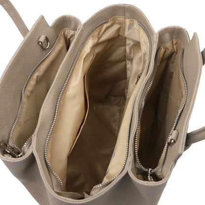 Open view of beige Italian leather handbag showing multiple zippered compartments and satin-lined interior pockets.