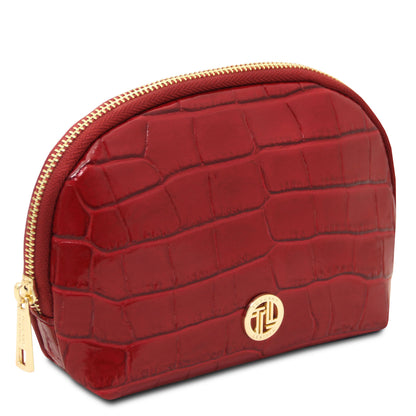 Vera - Croc print leather toiletry case in deep red with embossed texture, gold-tone hardware, and zip closure on white background.