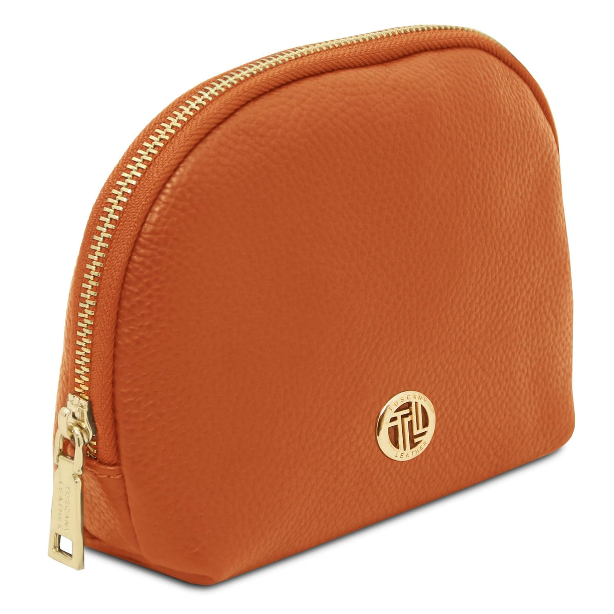 Soft textured Italian leather toiletry case in warm cuero with gold-tone zipper and round metal emblem detail.