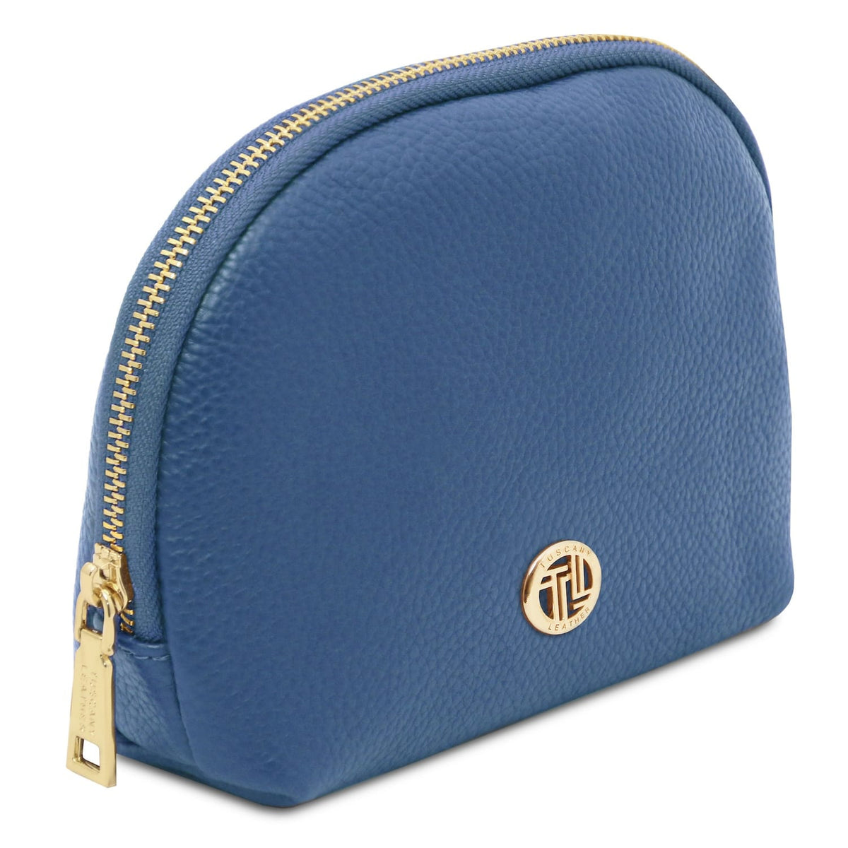 Blue piel suave toiletry case with gold-tone zipper and round metal emblem on pebbled Italian leather surface.