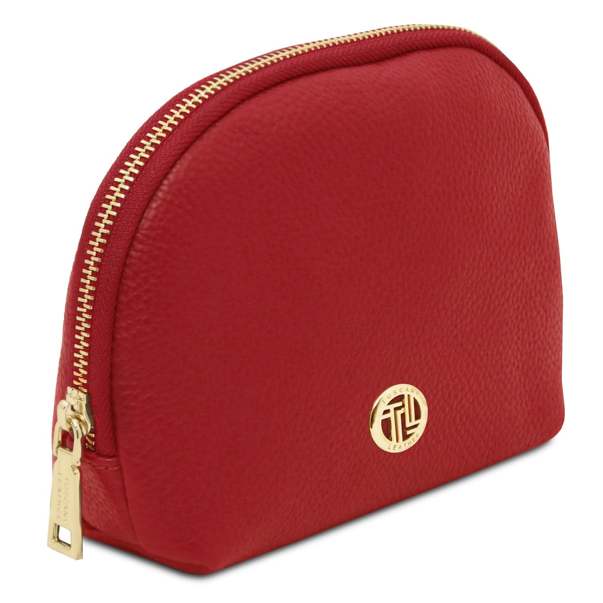 Top angled view of red piel granulada Vera toiletry case with a cremallera dorada along the curved edge.