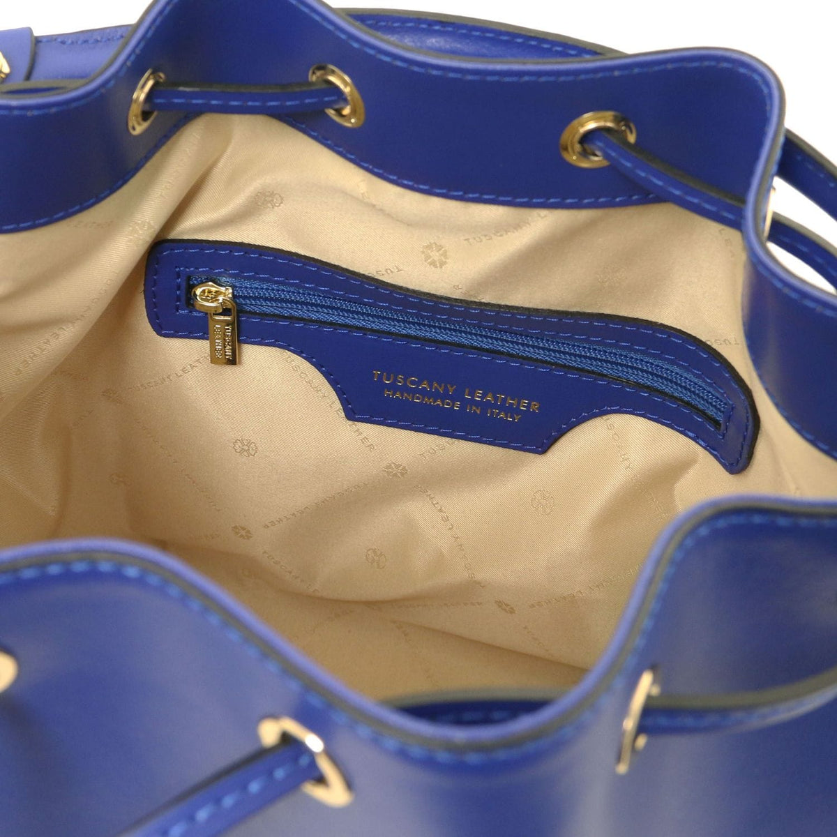 Interior of blue Vittoria bag with beige lining zip pocket and Tuscany Leather handmade in Italy label
