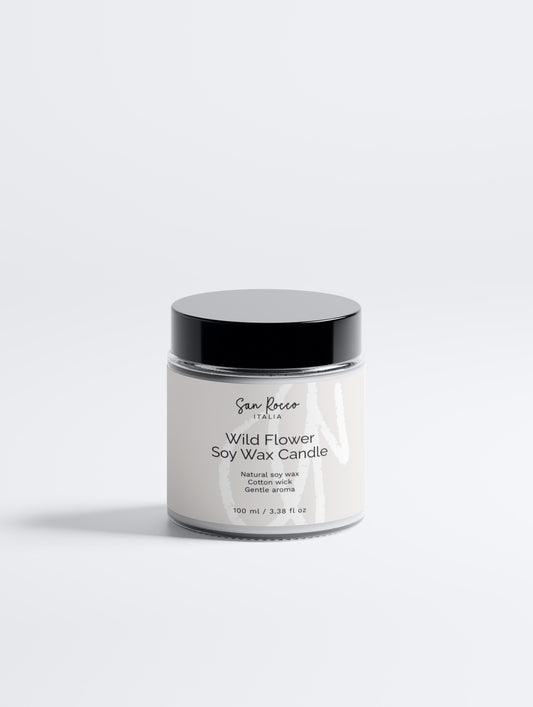 White candle jar with black lid on a white background