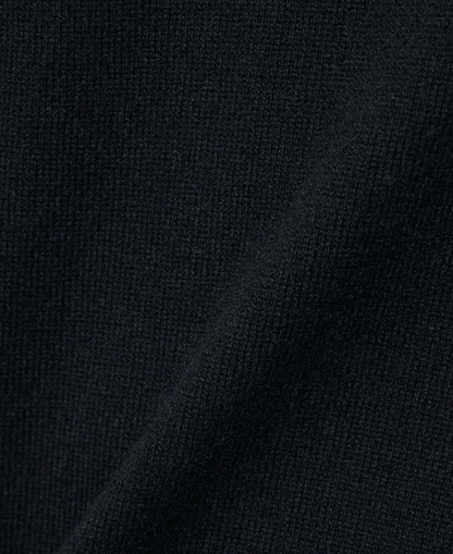 Close-up of deep navy fabric texture showcasing the soft knit weave of the Wool & Cashmere Mix High Neck Sweater with Zip.