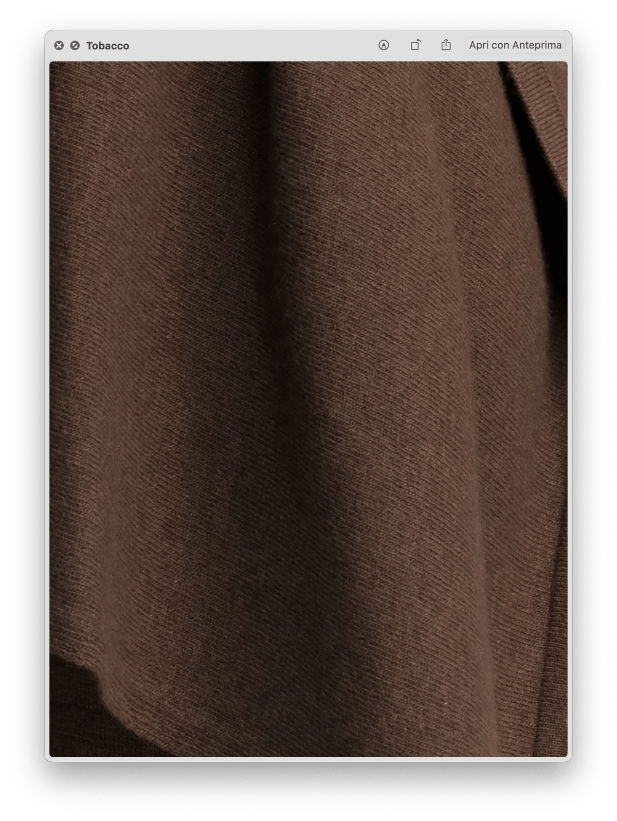 Close-up of the soft, smooth brown knit fabric texture of the Wool & Cashmere Mix Solid Maxi Turtleneck Sweater.